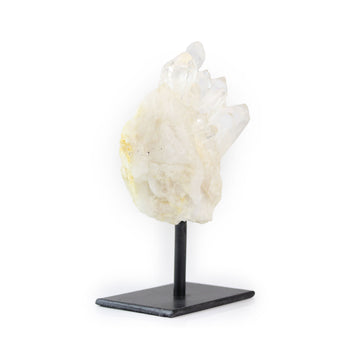 Raw quartz crystal on metal stand for home decor, left angled view against white background.